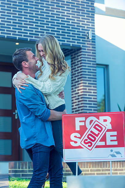 istock Couple standing in front of a new home. 507835632