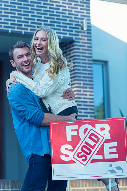 istock Couple standing in front of a new home. 507835742