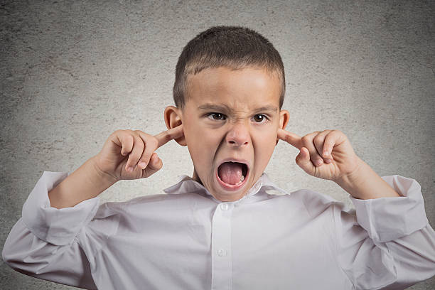 istock angry pissed off boy plugs his ears with fingers 507835862