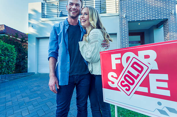 istock Couple standing in front of a new home. 507836494