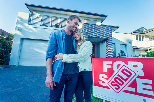 istock Couple standing in front of a new home. 507836724