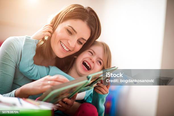 Mother And Little Daughter Stock Photo - Download Image Now - Reading, Parent, Toddler