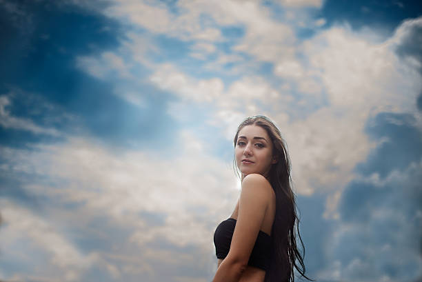 istock girl standing outdoors against the sky 507838796