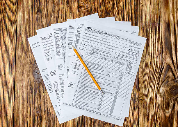 istock Pencil with tax form on wooden table 507839770
