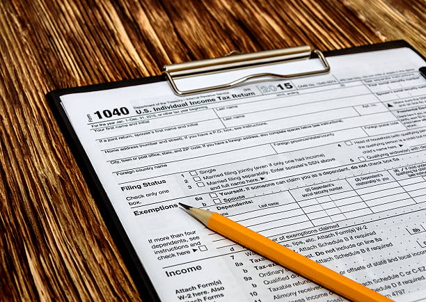 istock Pencil with tax form on wooden table 507839890