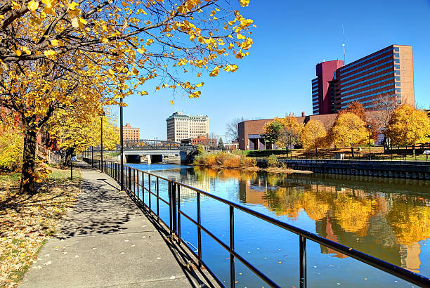 Autumn colors reflecting on the Flint River in Downtown Flint Michigan Beautiful Autumn colors reflecting on the Flint River in Downtown Flint Michigan flint michigan stock pictures, royalty-free photos & images