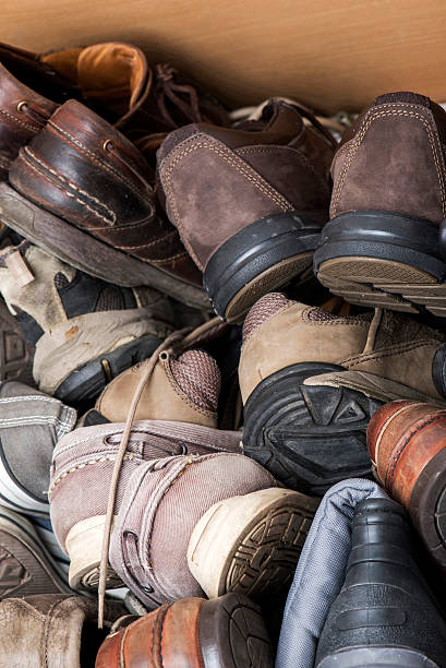 Heap of old shoes in the shoe cabinet.