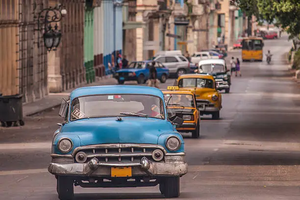 old cars traveling on the Paseo del Prado, Havana in Cuba