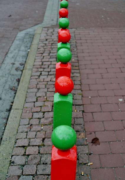 Fence in red-green color on pavement