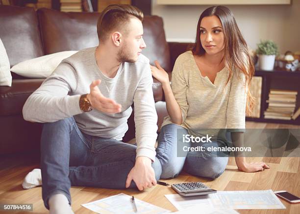 Young Beautiful Couple In Home Interior Stock Photo - Download Image Now - 1040 Tax Form, 20-29 Years, Adult