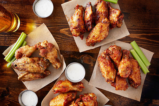 istock buffalo chicken wings with different flavors from overhead view 507845270