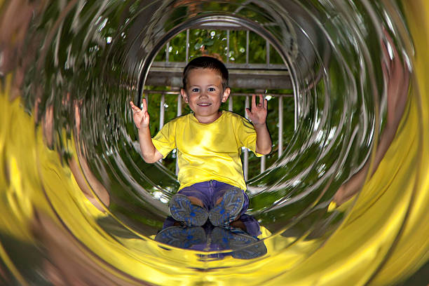 istock Little boy in playground tube 507848904