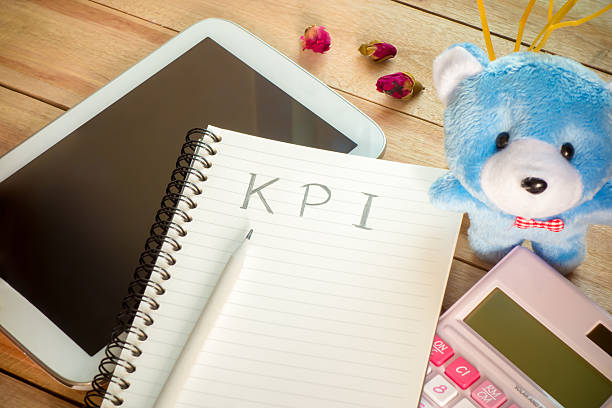 istock KPI list notebook with pencil and perfume on wood table 507849056