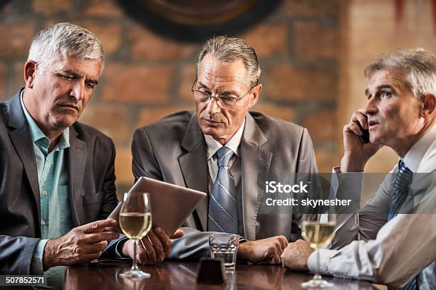 Businessmen In A Bar After Work Stock Photo - Download Image Now - Active Seniors, Adult, Adults Only