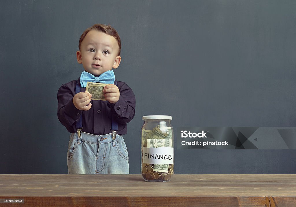 Saving money Little child is saving money for the future. 2-3 Years Stock Photo