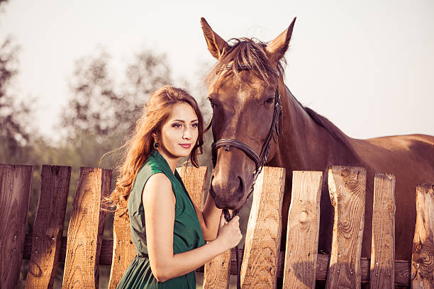 istock woman and brown horse 507852859