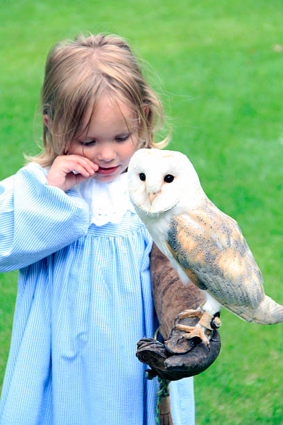 istock blonde child with owl 507852917
