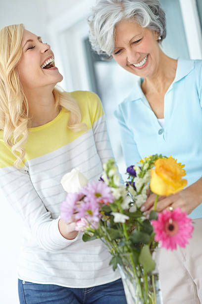 Shot of a senior woman enjoying some flower arranging with her daughter