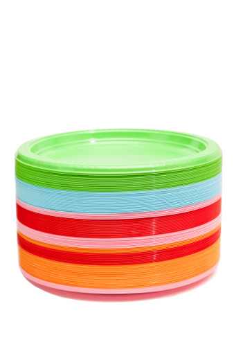 Stack of color plastic plates isolated on white