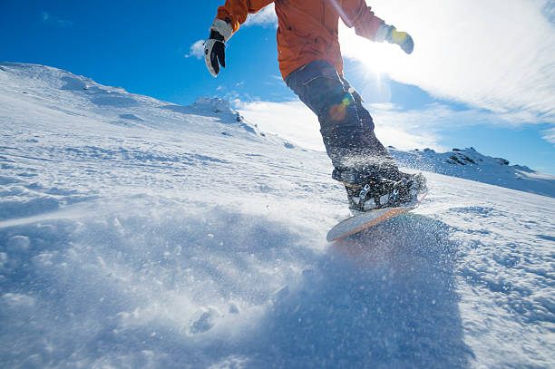 istock Snowboarder turning on a blue sky day 507855425