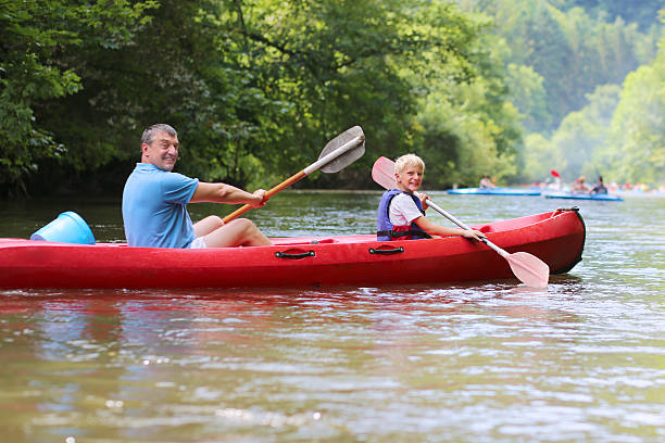 istock Happy father and son kayaking on the river 507857415