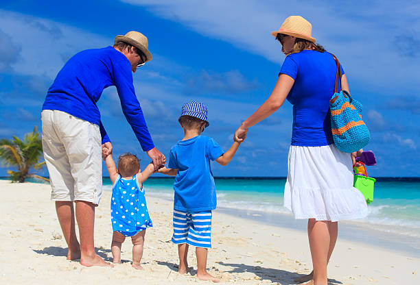 istock family with kids walking on tropical beach 507859585
