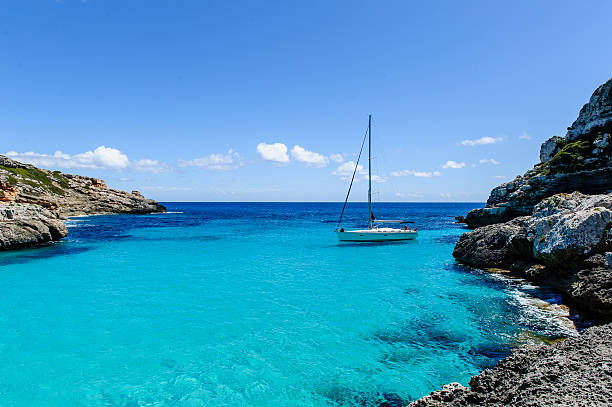 istock Sailing boat at anchor. Paradise wild bay. Cala Marmolis. 507860001