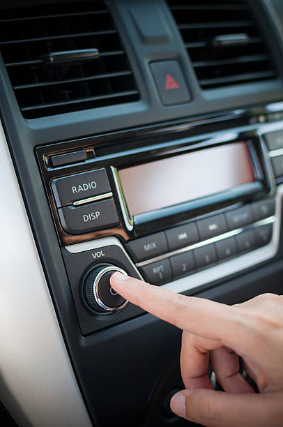 Driver finger pushing button of car audio player. stock photo