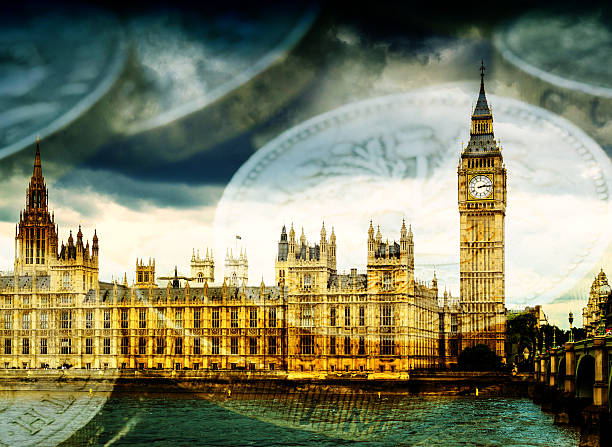 Big Ben and Houses of Parliament with Money Famous London Tourist attraction Big Ben and the Houses of Parliament in England, with stacks of English Pound coins. Concept image suggesting money and government finances. government large currency finance stock pictures, royalty-free photos & images