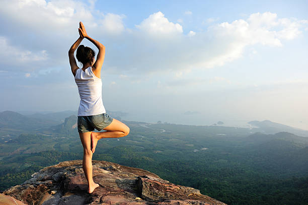 istock yoga woman mountain peak 507867950