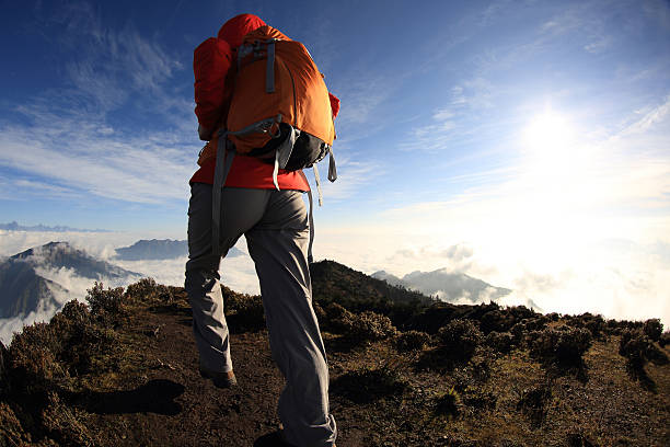 istock young woman hiker on beautiful rolling clouds mountain peak 507872178
