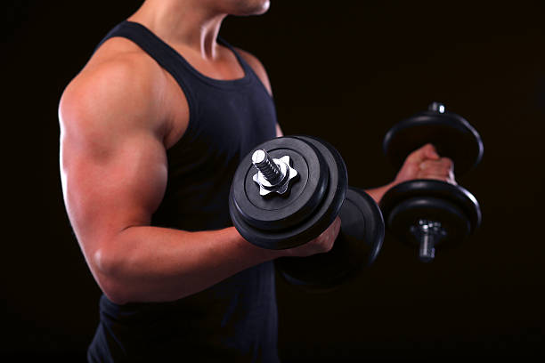 istock Handsome muscular man working out with dumbbells 507873078