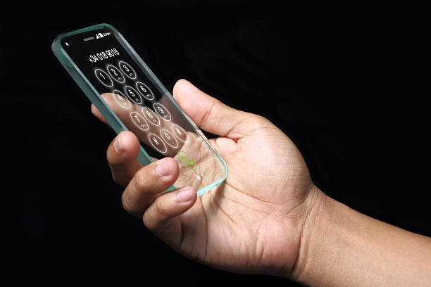 istock Transparent smartphone with hand on dark background. 507873870