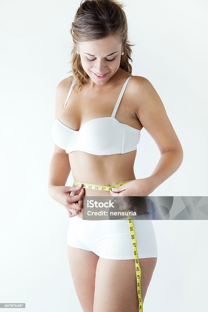 Fitness Woman With Tape Measure Showing Her Waist Stock Photo