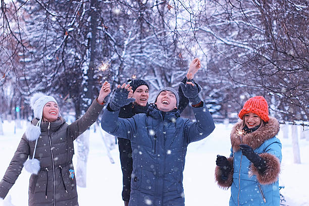 istock group of young people with sparklers on holidays 507877054