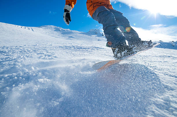 istock Snowboarder turning on a blue sky day 507877367