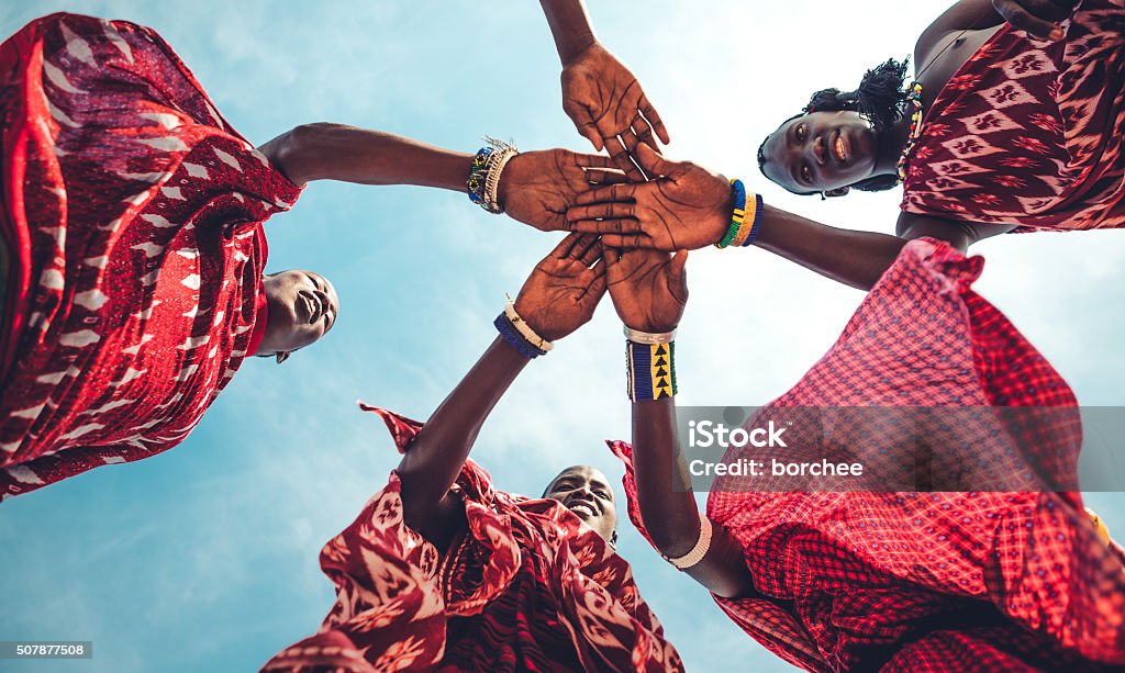 Masai Unity Masai in traditional clothes joining hands in unity (Zanzibar, Tanzania), Africa Stock Photo