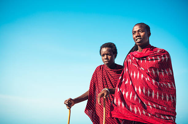 Masai warriors in traditional clothing staring into the distance. (Zanzibar, Africa).