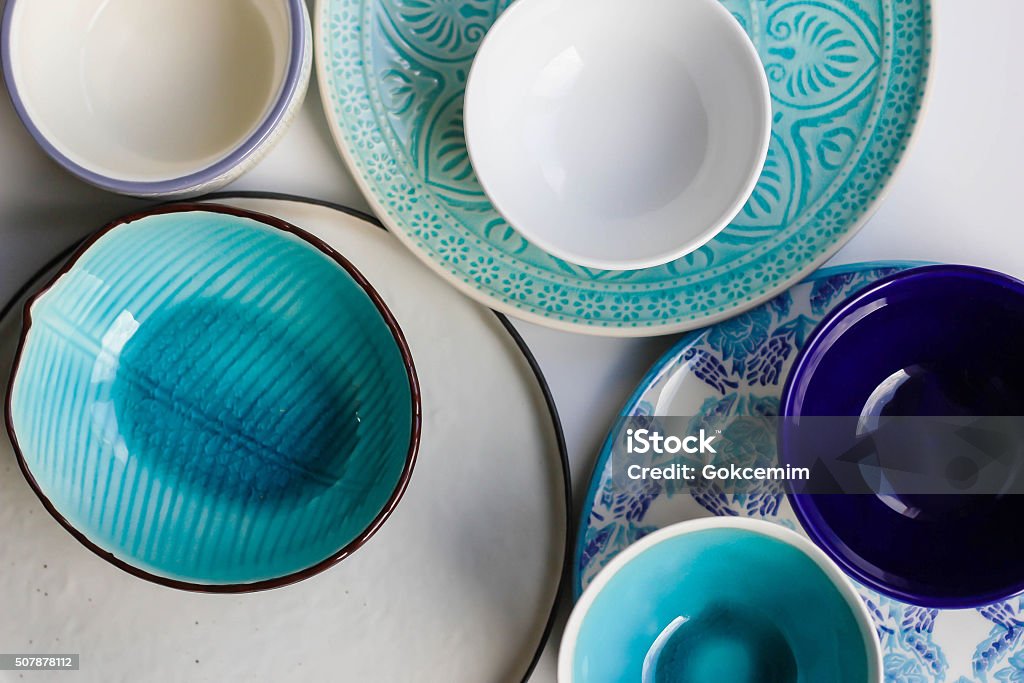 Stack of Plates and Bowls Stack of blue and white plates and bowls isolated on white background. Crockery Stock Photo