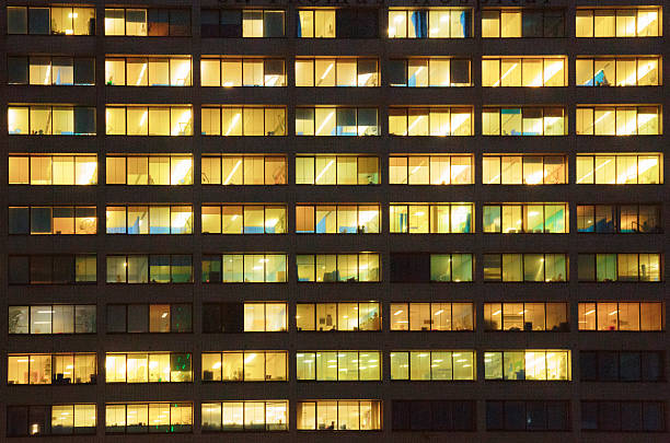 istock Windows of office building at night 507878355