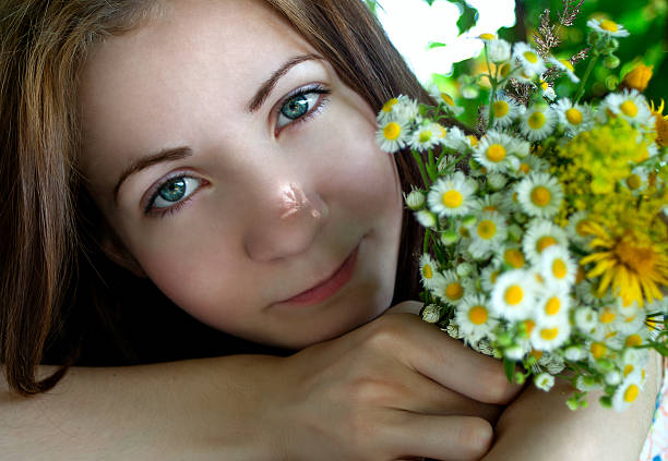 The beautiful girl with spring flowers in hair