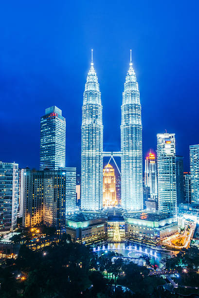 Kuala Lumpur at dusk A cityscape with Petronas towers of the downtown area of Kuala Lumpur, capital city of Malaysia twin towers malaysia stock pictures, royalty-free photos & images