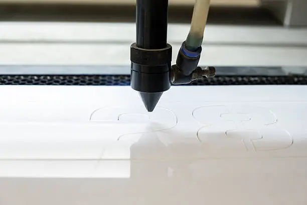 Photo of cutting machine carving patterns on the plastic plate