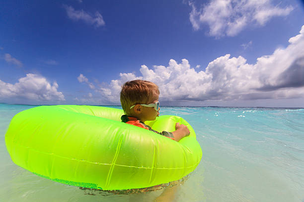 istock little boy swimming at the beach 507881865