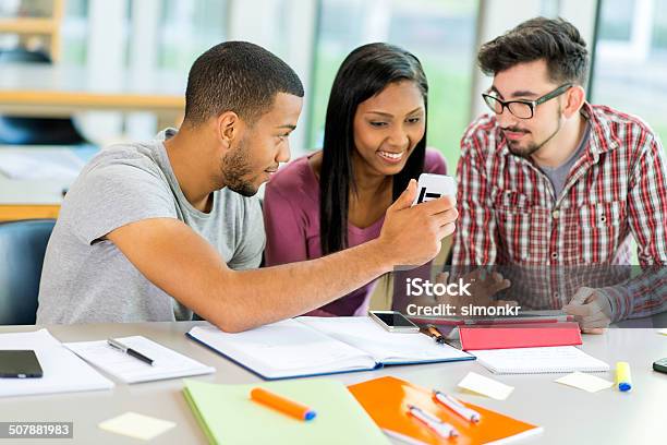 Students Using Mobile Phone And Tablet Stock Photo - Download Image Now - 20-29 Years, Adult, Adult Student