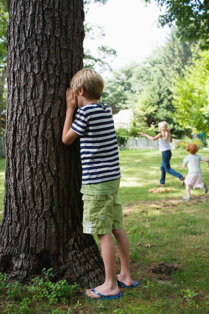istock Boy Covering Eyes In Garden 507882641