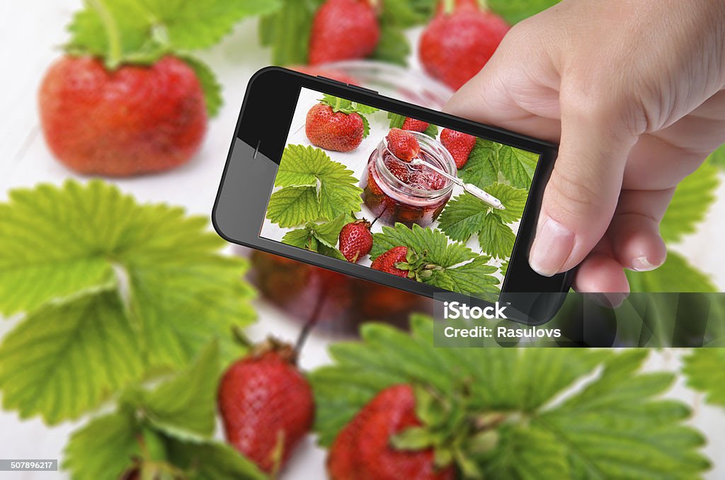 photo strawberry jam Hands taking photo strawberry jam with smartphone Auto Post Production Filter Stock Photo