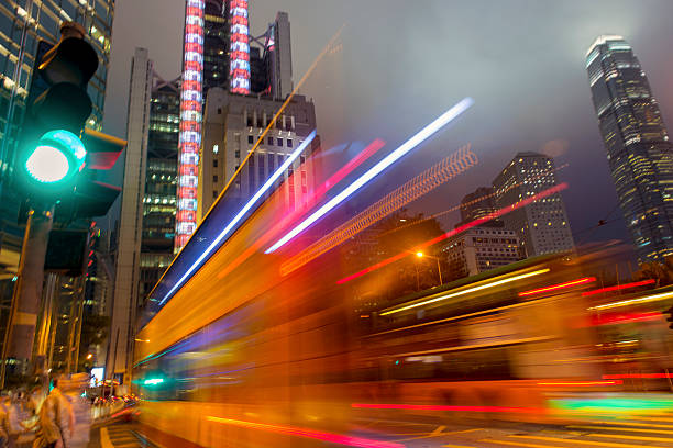 Bus in Hong Kong speeding in Central District. Higher ISO, slightly motion blurred.