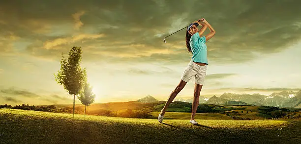 Photo of Woman golfer hitting the ball on background scenery  beautiful