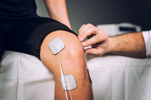TENS electrodes positioned to treat knee pain in physical therapy